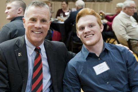 President Huntington pictured with a student in 2019